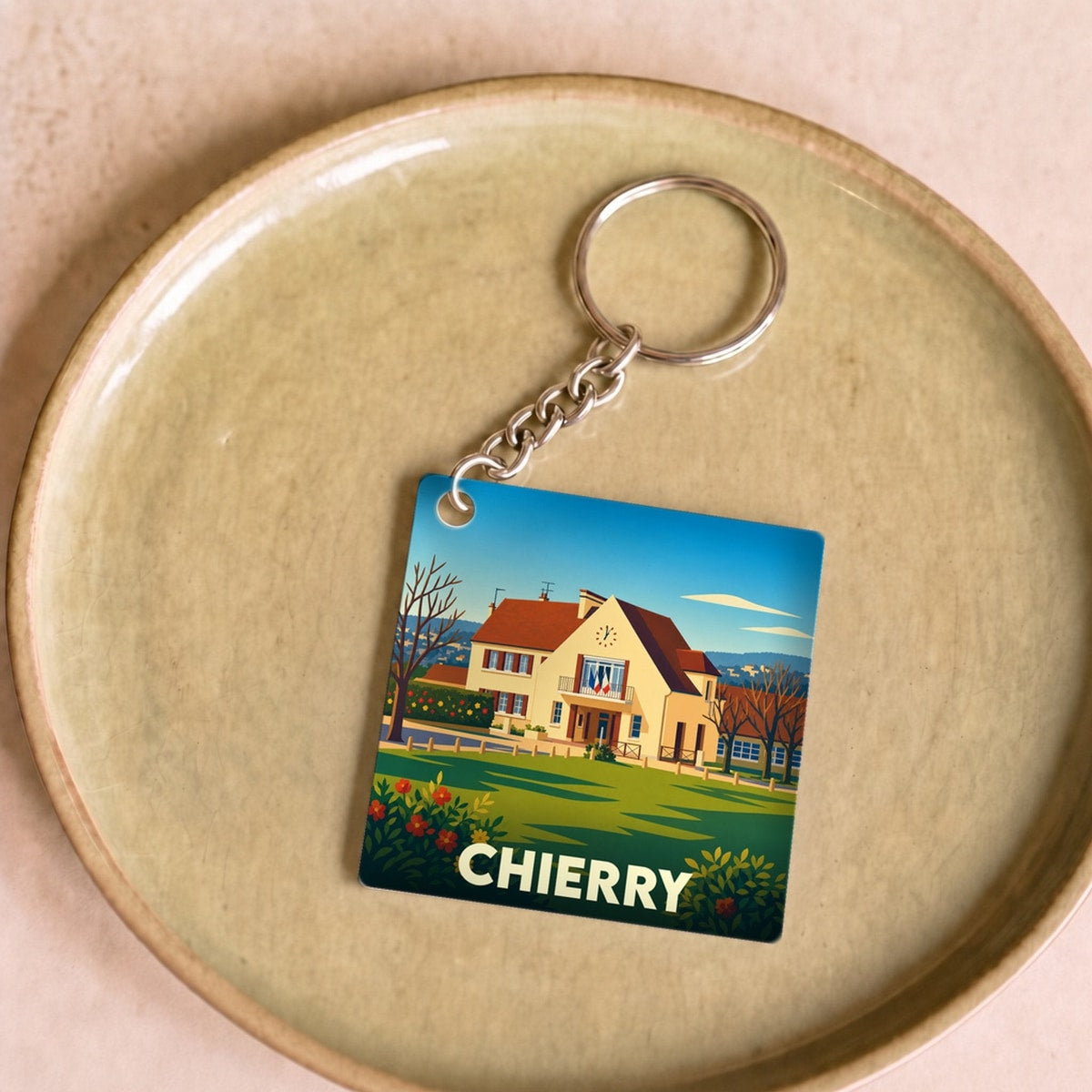 Porte-clés souvenir de la ville de Chierry avec une illustration stylisée de sa mairie.