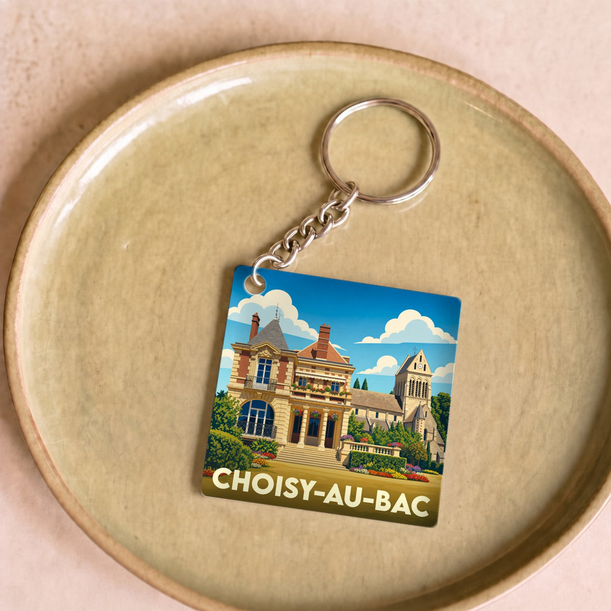 Porte-clés souvenir de la ville de Choisy-au-Bac avec une illustration stylisée de son patrimoine.