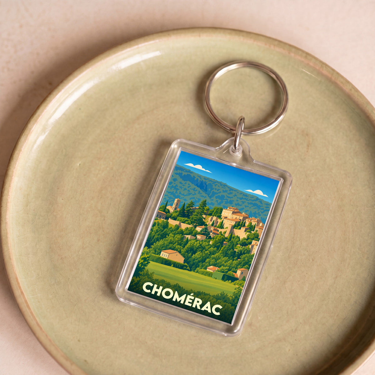 Porte-clés souvenir de la ville de Chomérac avec une illustration stylisée.