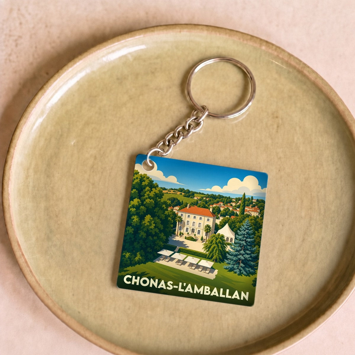 Porte-clés souvenir de la ville de Chonas-l'Amballan avec une illustration stylisée.