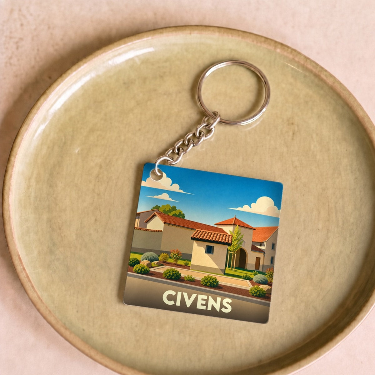 Porte-clés souvenir de la ville de Civens avec une illustration stylisée.