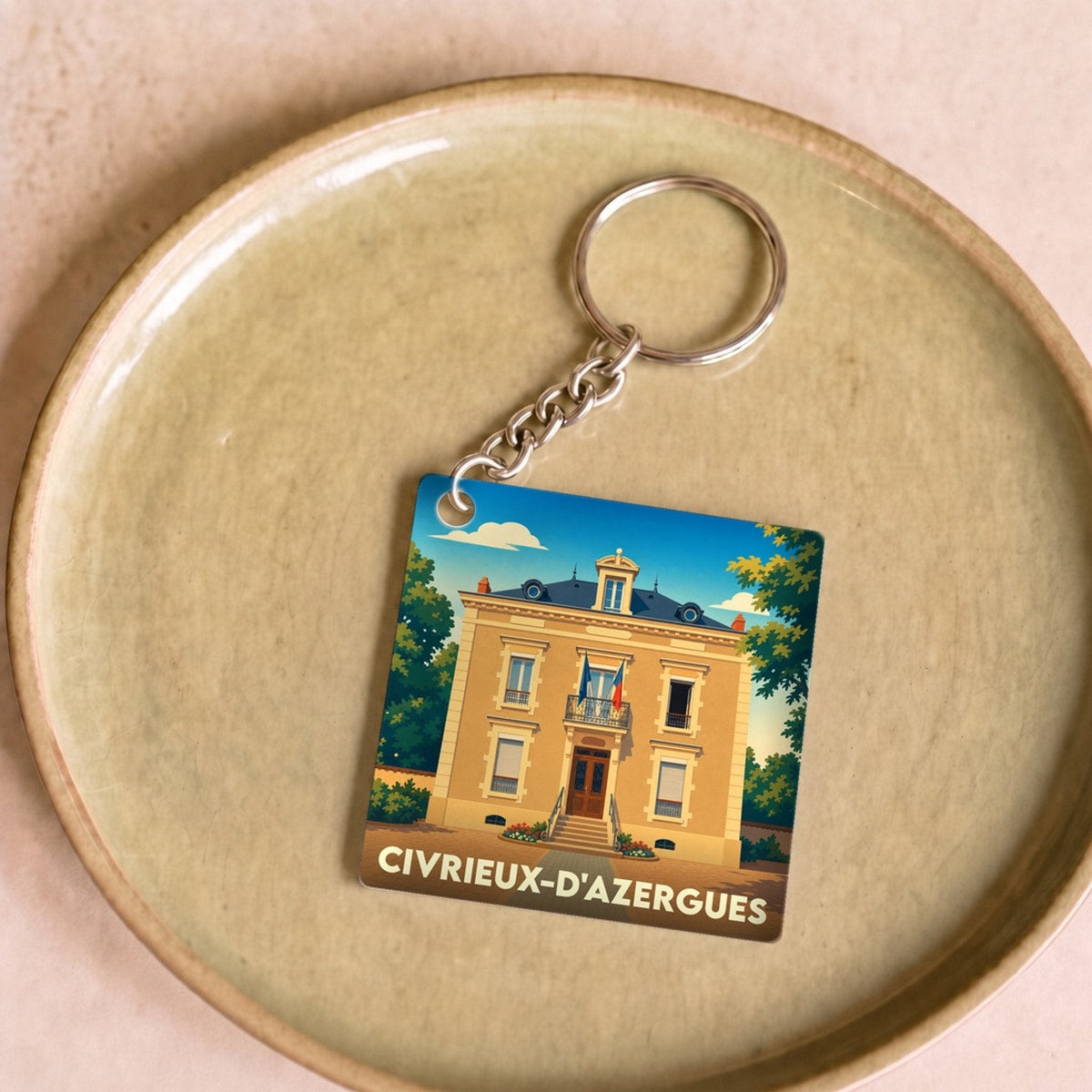 Porte-clés souvenir de la ville de Civrieux-d'Azergues avec une illustration stylisée.
