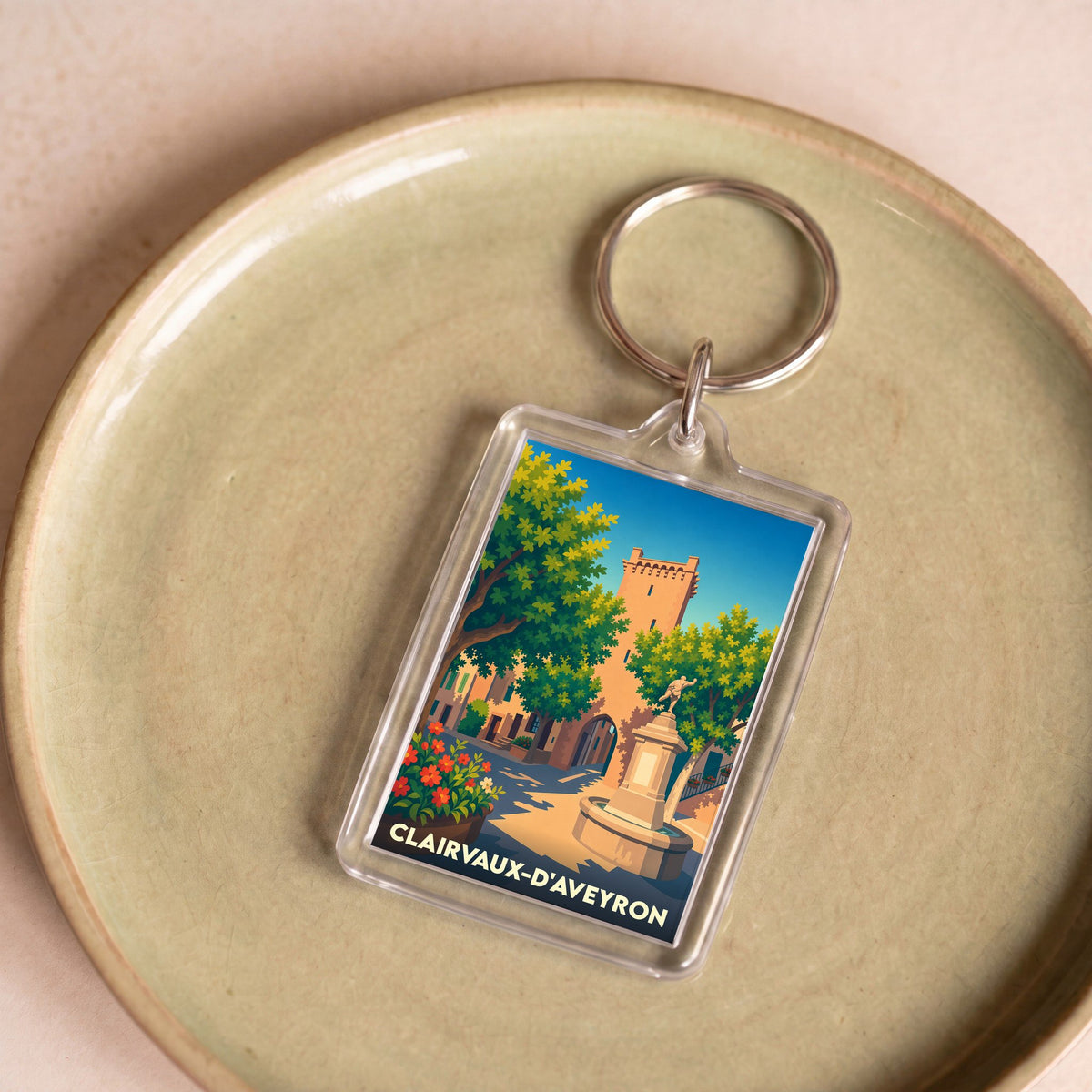 Porte-clés souvenir de la ville de Clairvaux-d'Aveyron avec une illustration stylisée.