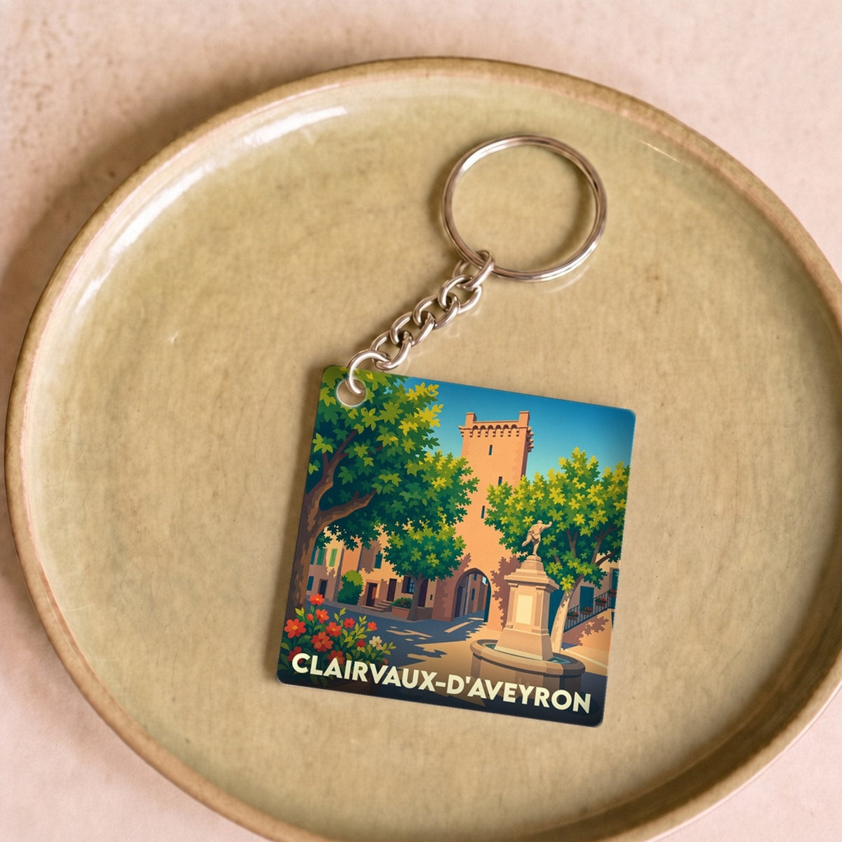 Porte-clés souvenir de la ville de Clairvaux-d'Aveyron avec une illustration stylisée.