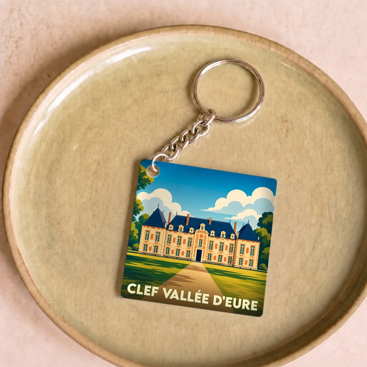Porte-clés souvenir de la commune de Clef Vallée d'Eure avec une illustration stylisée de son château.