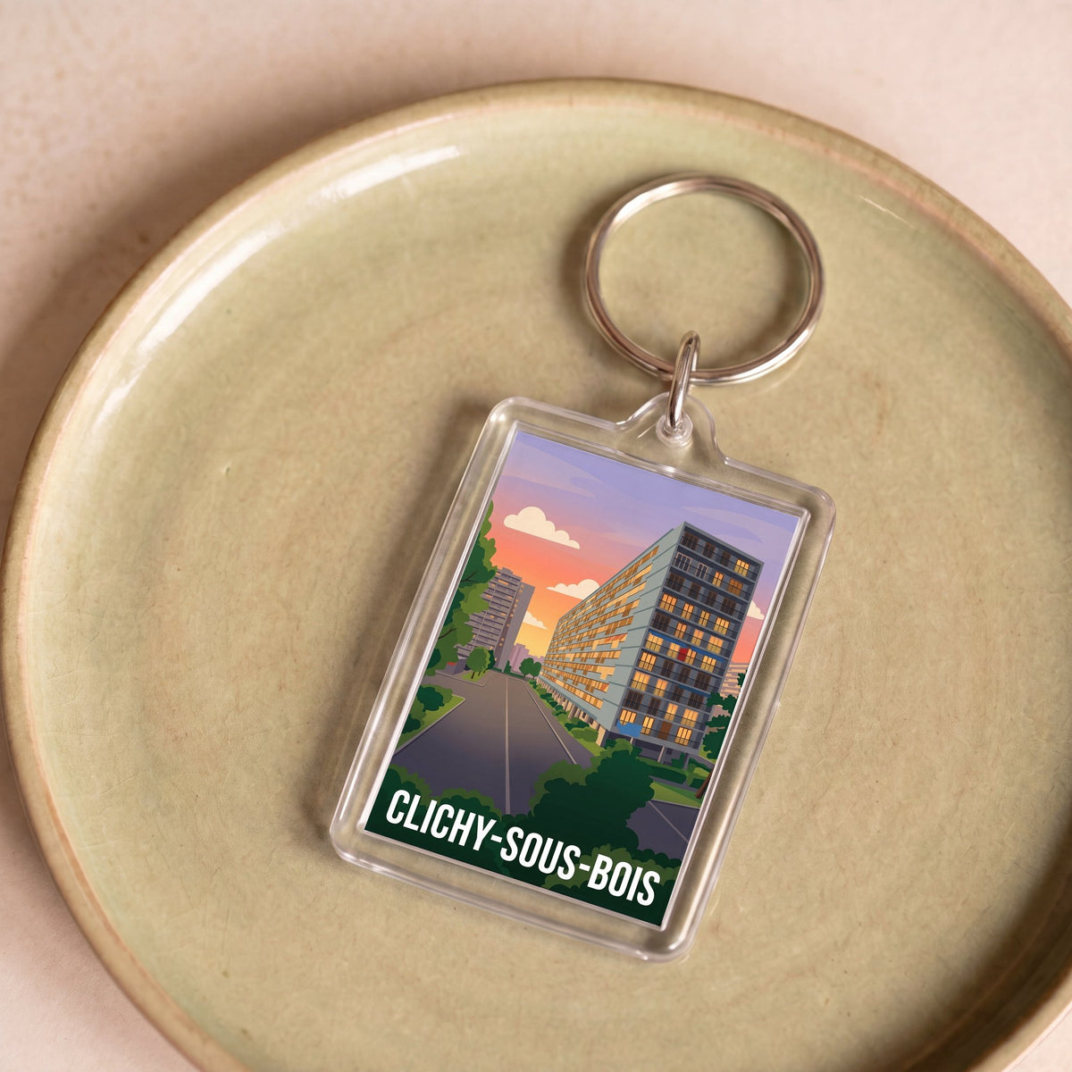 Porte-clés souvenir de la ville de Clichy-sous-Bois avec une illustration stylisée.