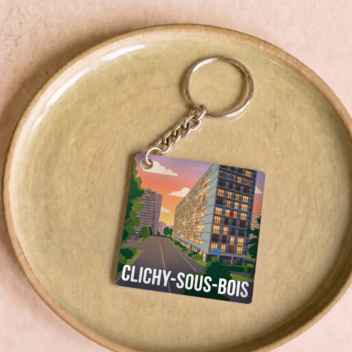 Porte-clés souvenir de la ville de Clichy-sous-Bois avec une illustration stylisée.