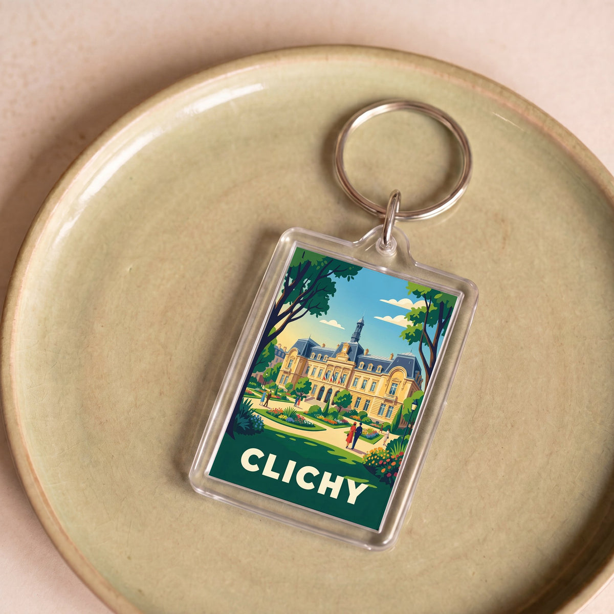 Porte-clés souvenir de la ville de Clichy avec une illustration stylisée.