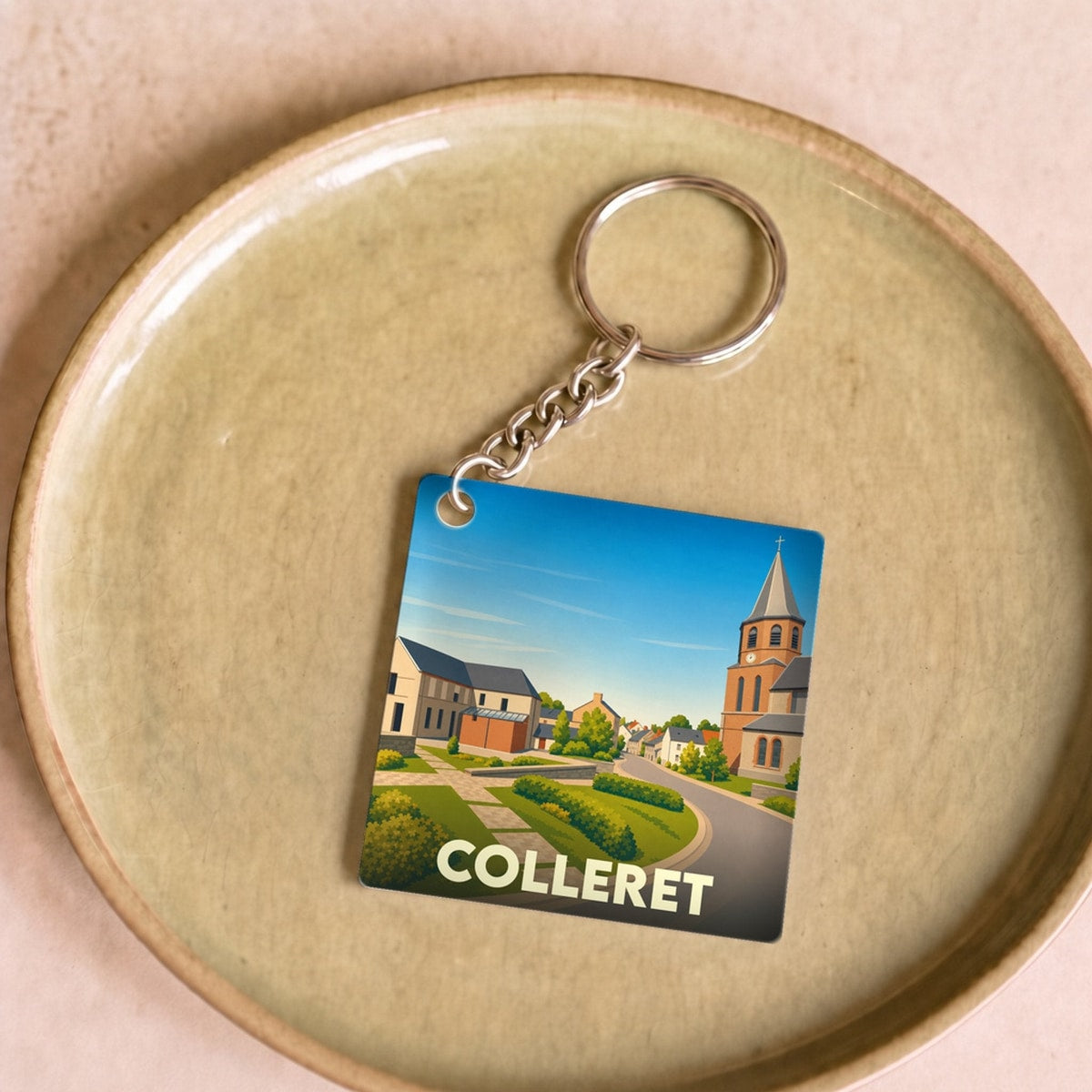 Porte-clés souvenir de la ville de Colleret avec une illustration stylisée.