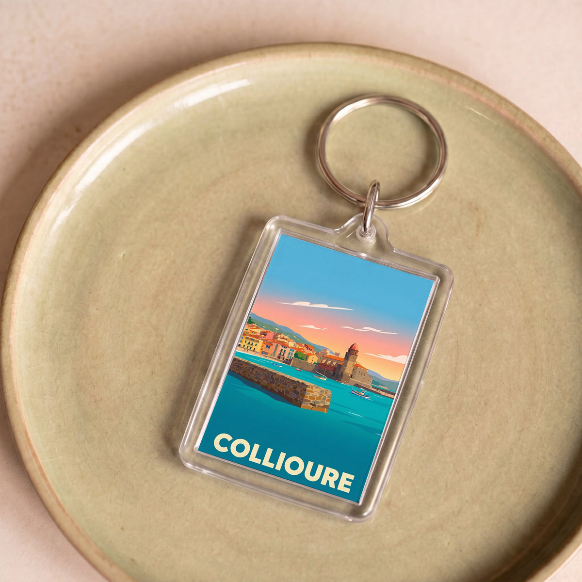 Porte-clés souvenir de la ville de Collioure avec une illustration stylisée de son front de mer.