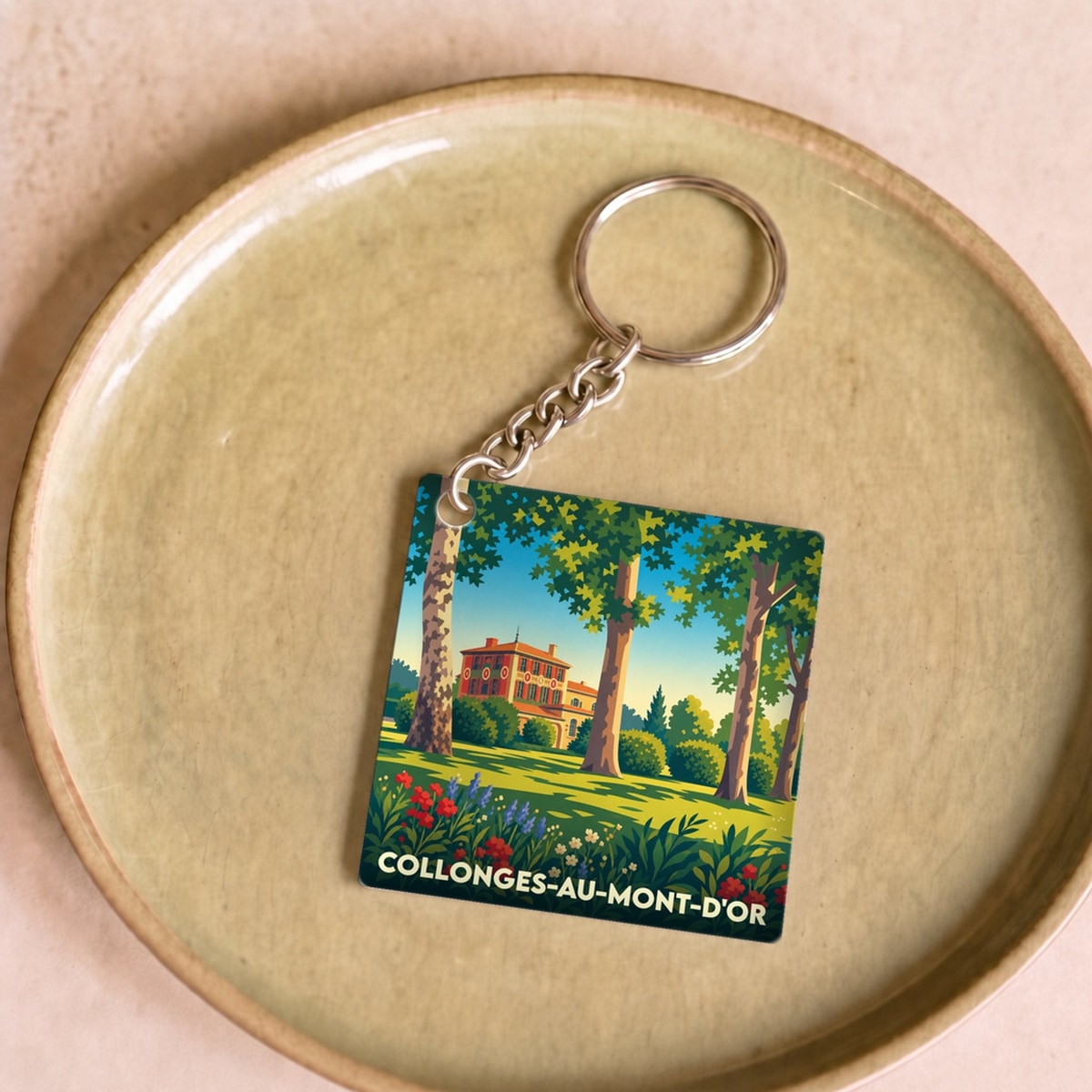 Porte-clés souvenir de la ville de Collonges-au-Mont-d'Or avec une illustration stylisée.