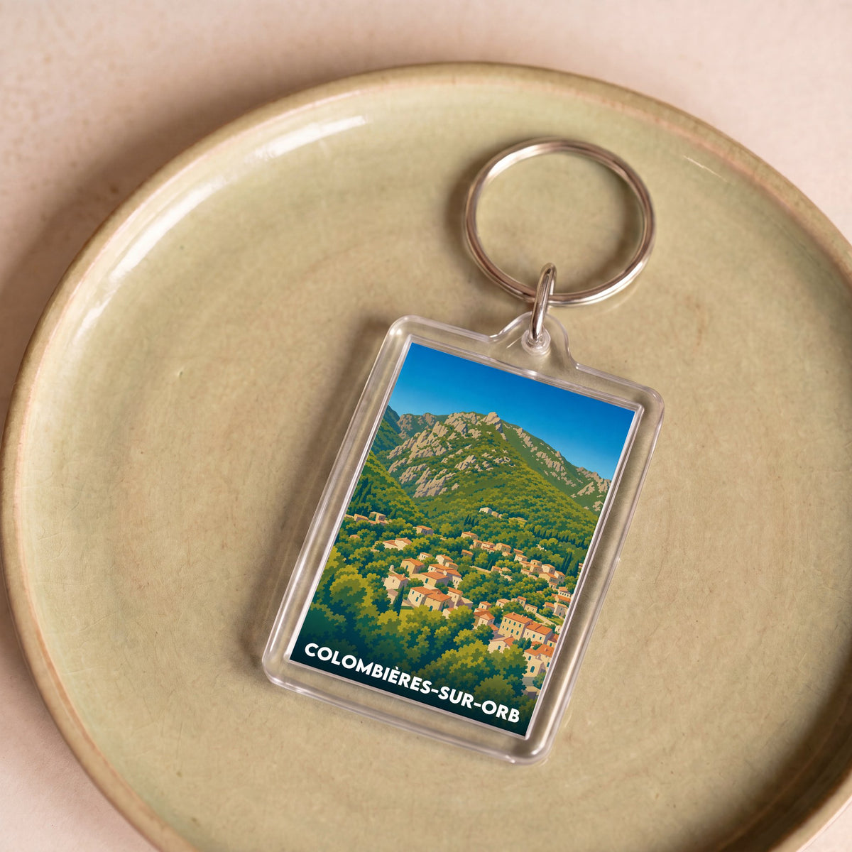 Porte-clés souvenir de la ville de Colombières-sur-Orb avec une illustration stylisée.