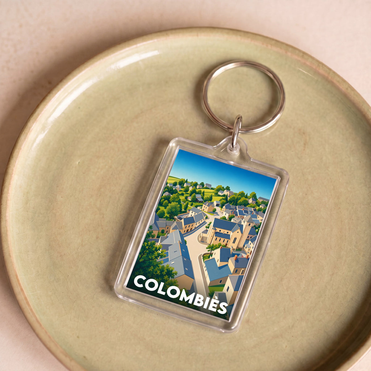 Porte-clés souvenir de la ville de Colombiès avec une illustration stylisée du village.