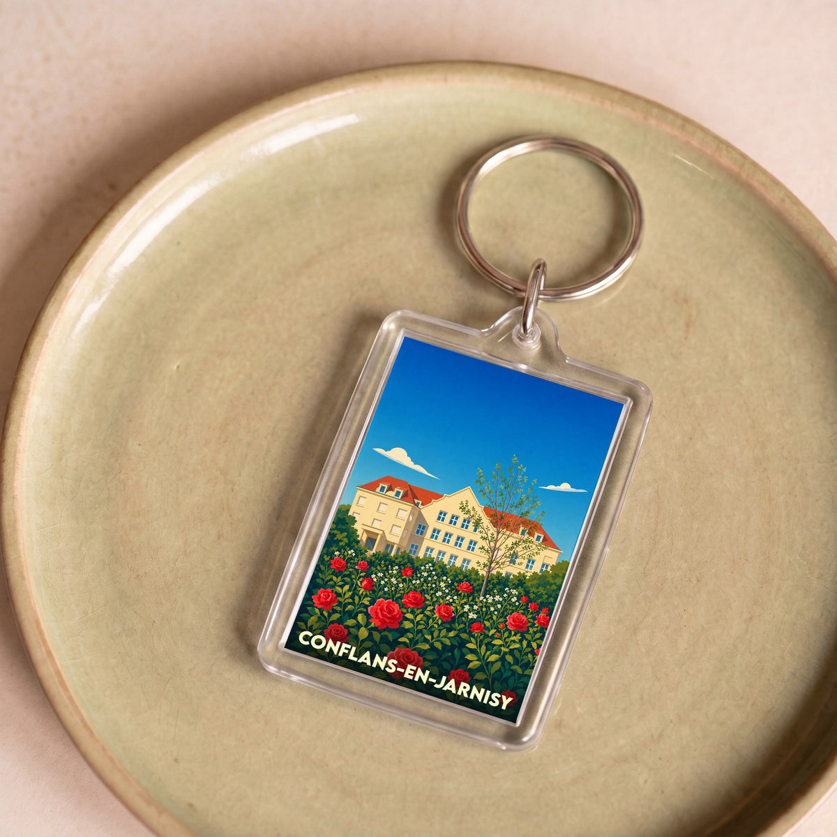Porte-clés souvenir de la ville de Conflans-en-Jarnisy avec une illustration stylisée.