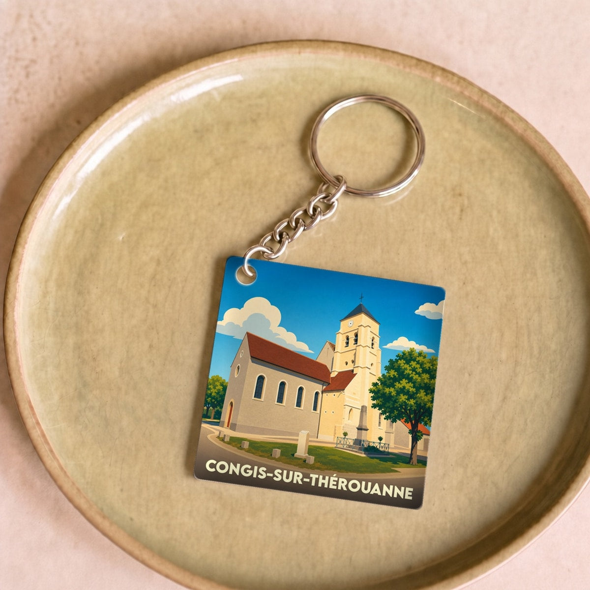 Porte-clés souvenir de la ville de Congis-sur-Thérouanne avec une illustration stylisée de son église.