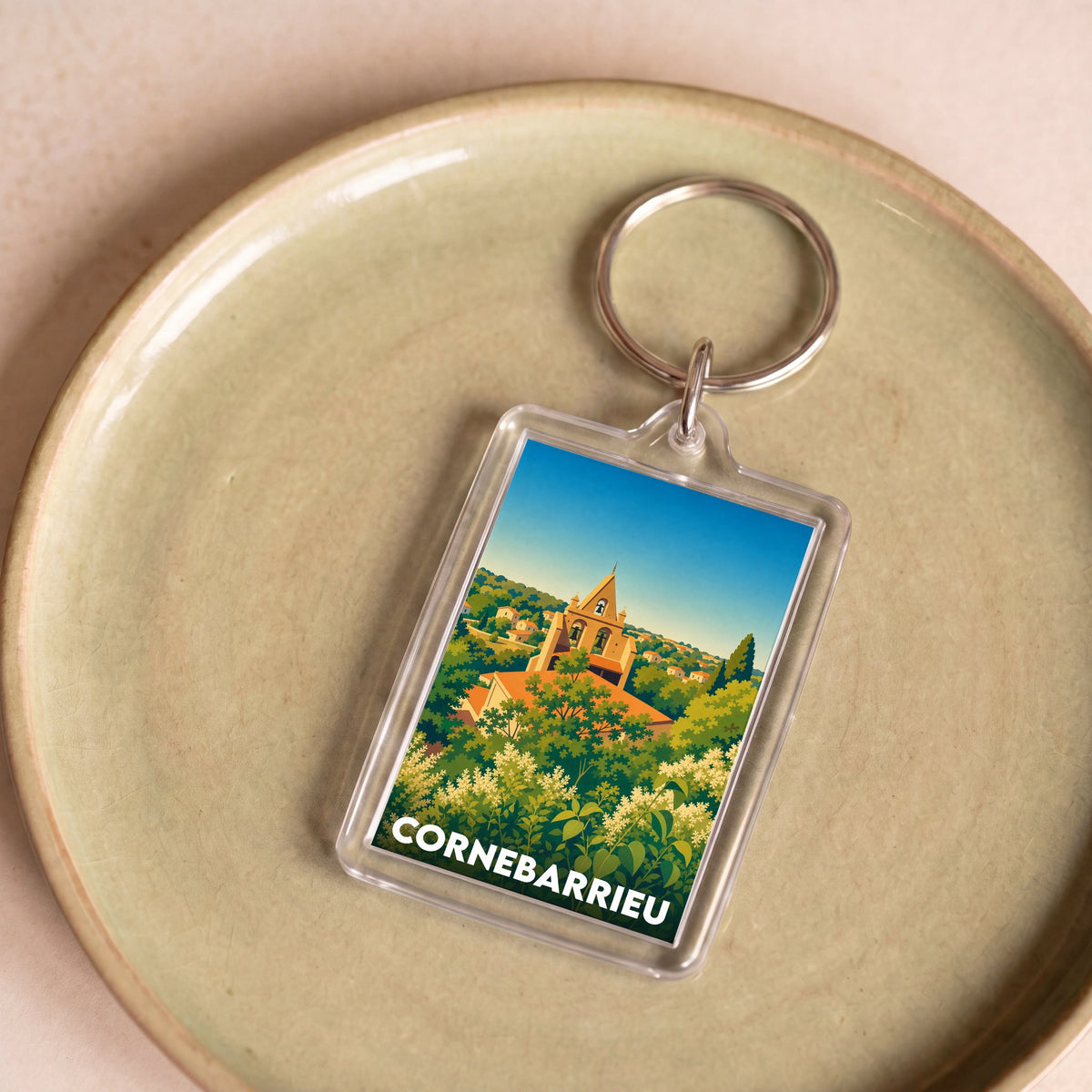 Porte-clés souvenir de la ville de Cornebarrieu avec une illustration stylisée d'un paysage urbain verdoyant.