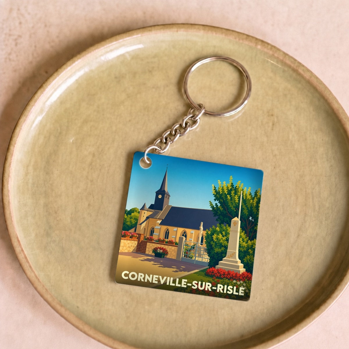 Porte-clés souvenir de la ville de Corneville-sur-Risle avec une illustration stylisée.