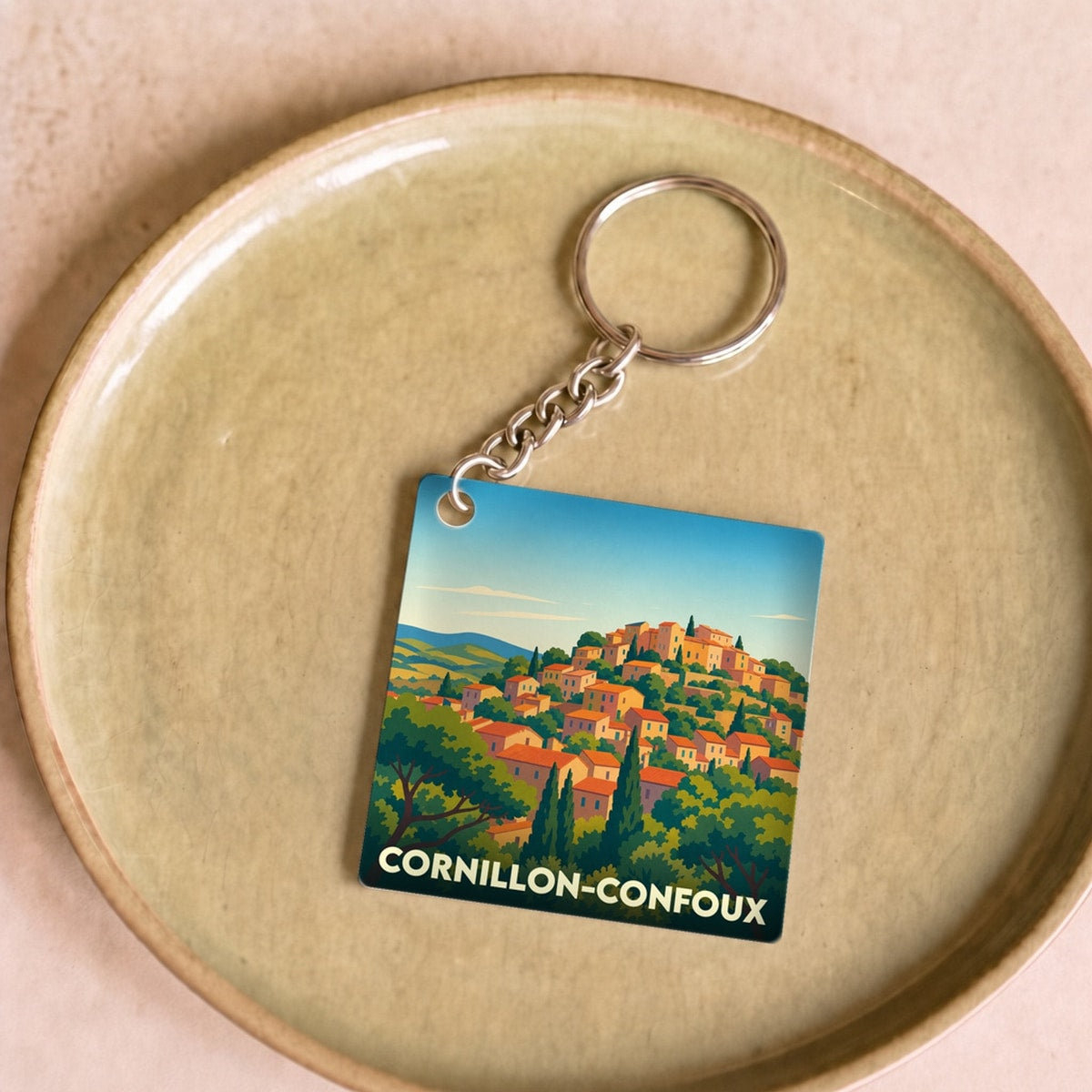 Porte-clés souvenir de la ville de Cornillon-Confoux avec une illustration stylisée.