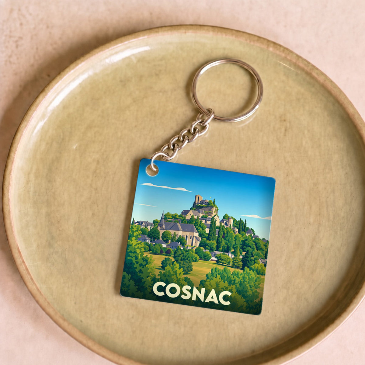 Porte-clés souvenir de la ville de Cosnac avec une illustration stylisée.