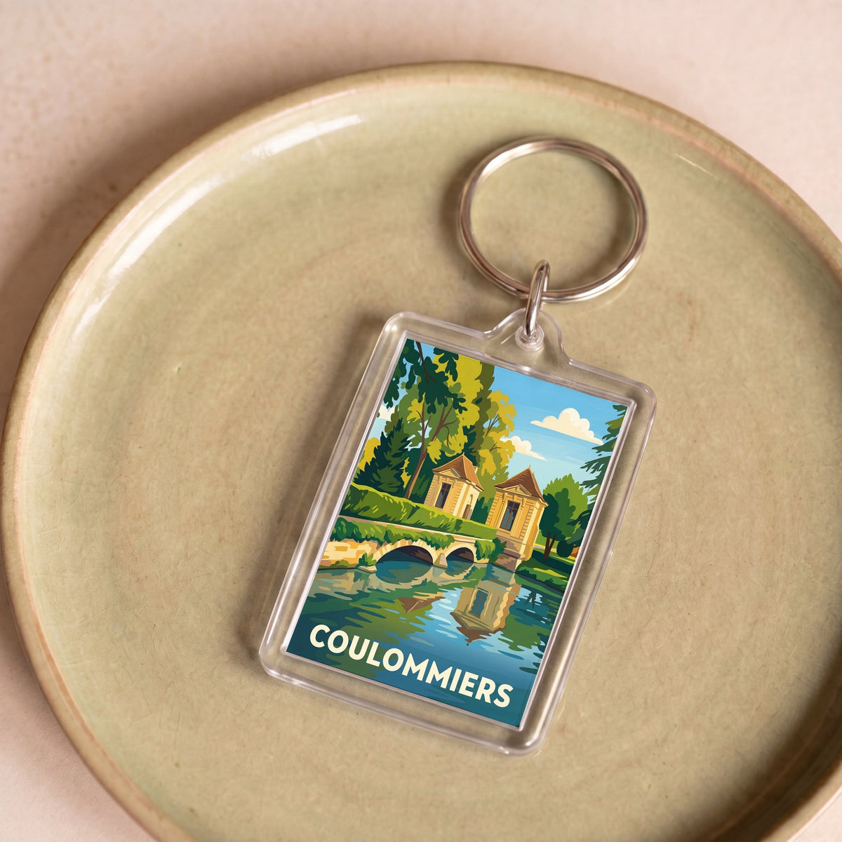 Porte-clés souvenir de la ville de Coulommiers avec une illustration stylisée.
