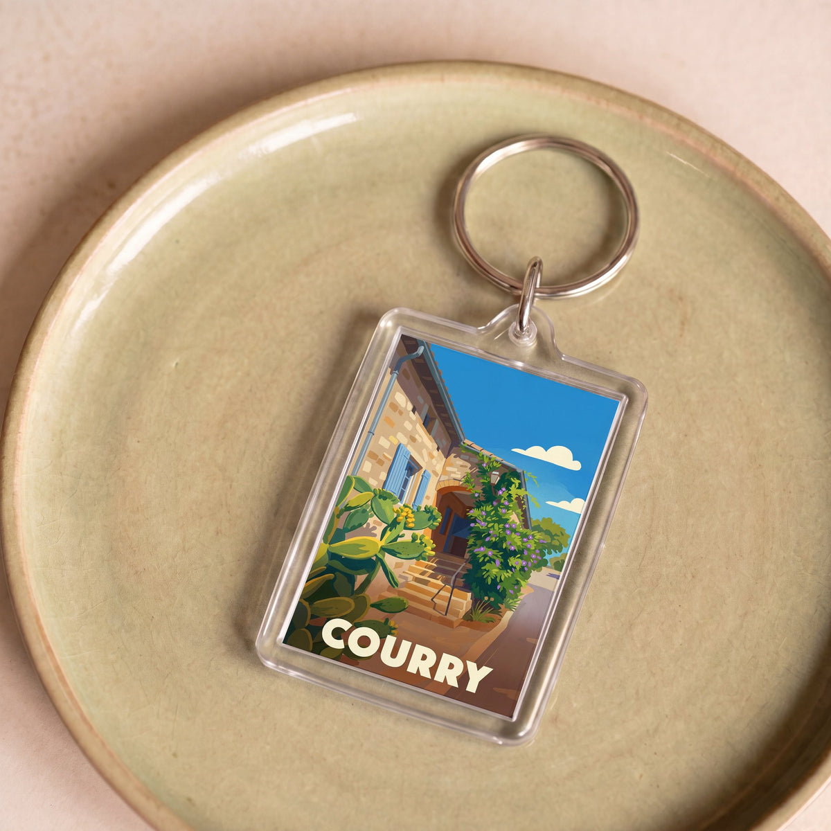 Porte-clés souvenir de la ville de Courry avec une illustration stylisée.
