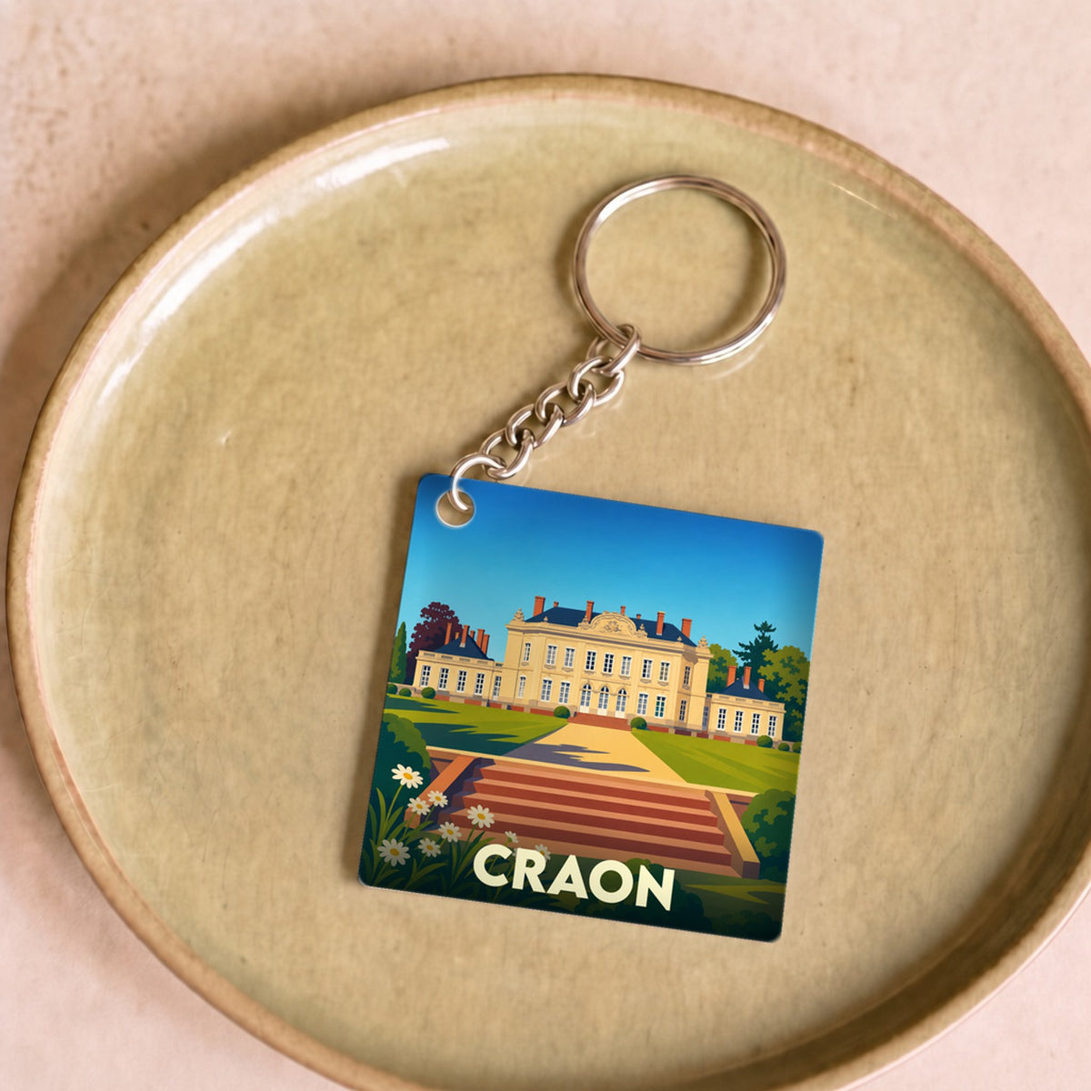 Porte-clés souvenir de la ville de Craon avec une illustration stylisée de son château.