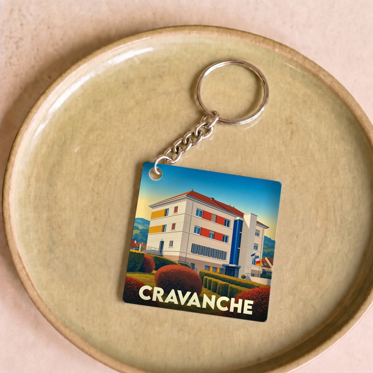 Porte-clés souvenir de la ville de Cravanche avec une illustration stylisée.