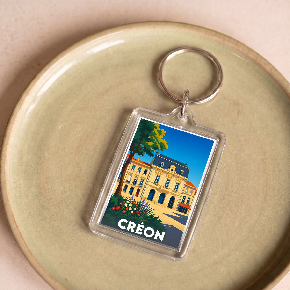 Porte-clés souvenir de la ville de Créon avec une illustration stylisée.