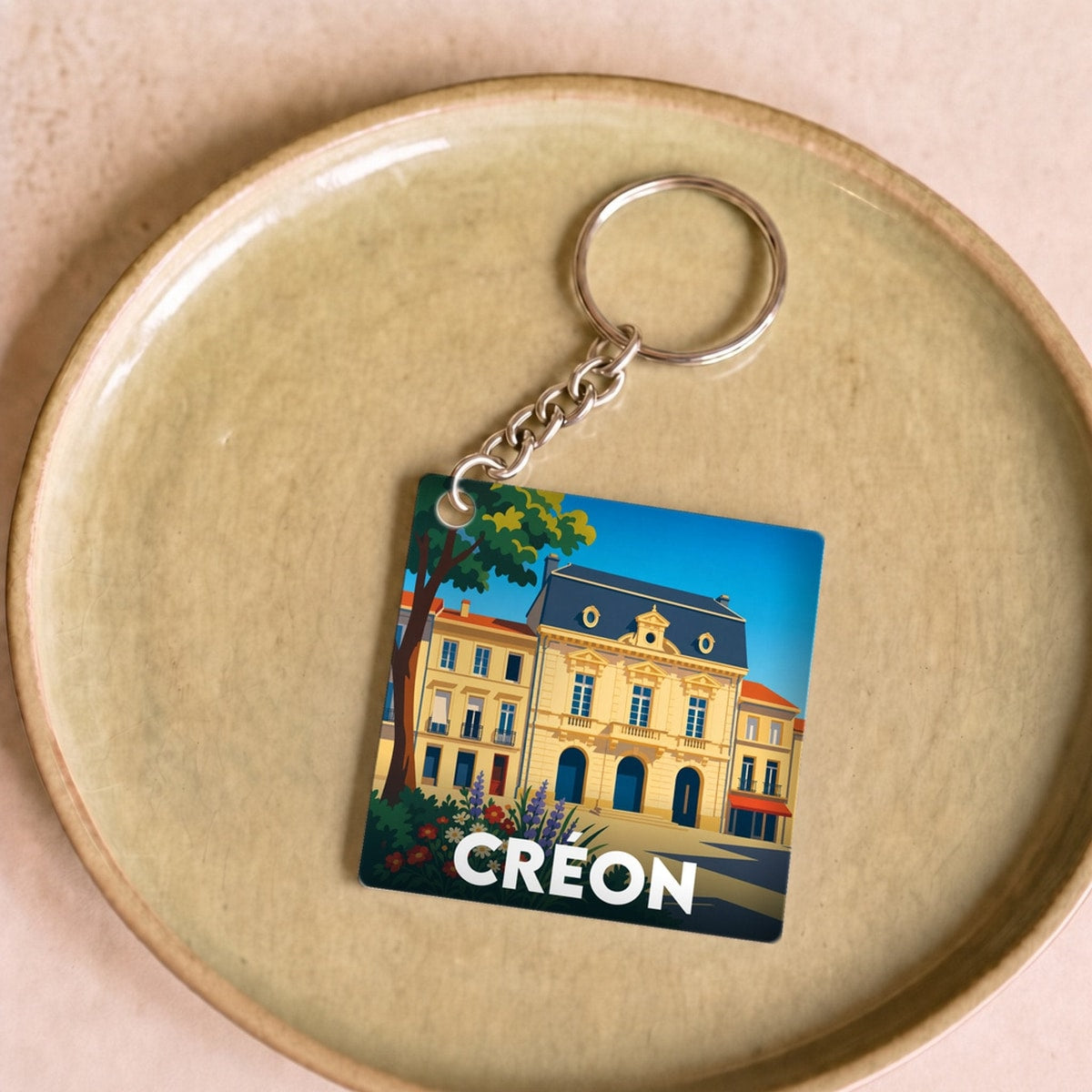Porte-clés souvenir de la ville de Créon avec une illustration stylisée.