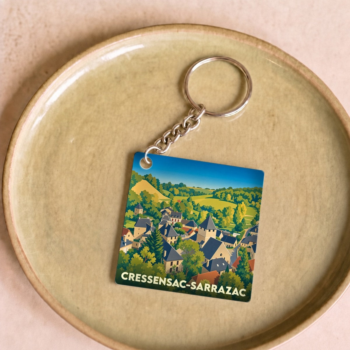 Porte-clés souvenir de la ville de Cressensac-Sarrazac avec une illustration stylisée.