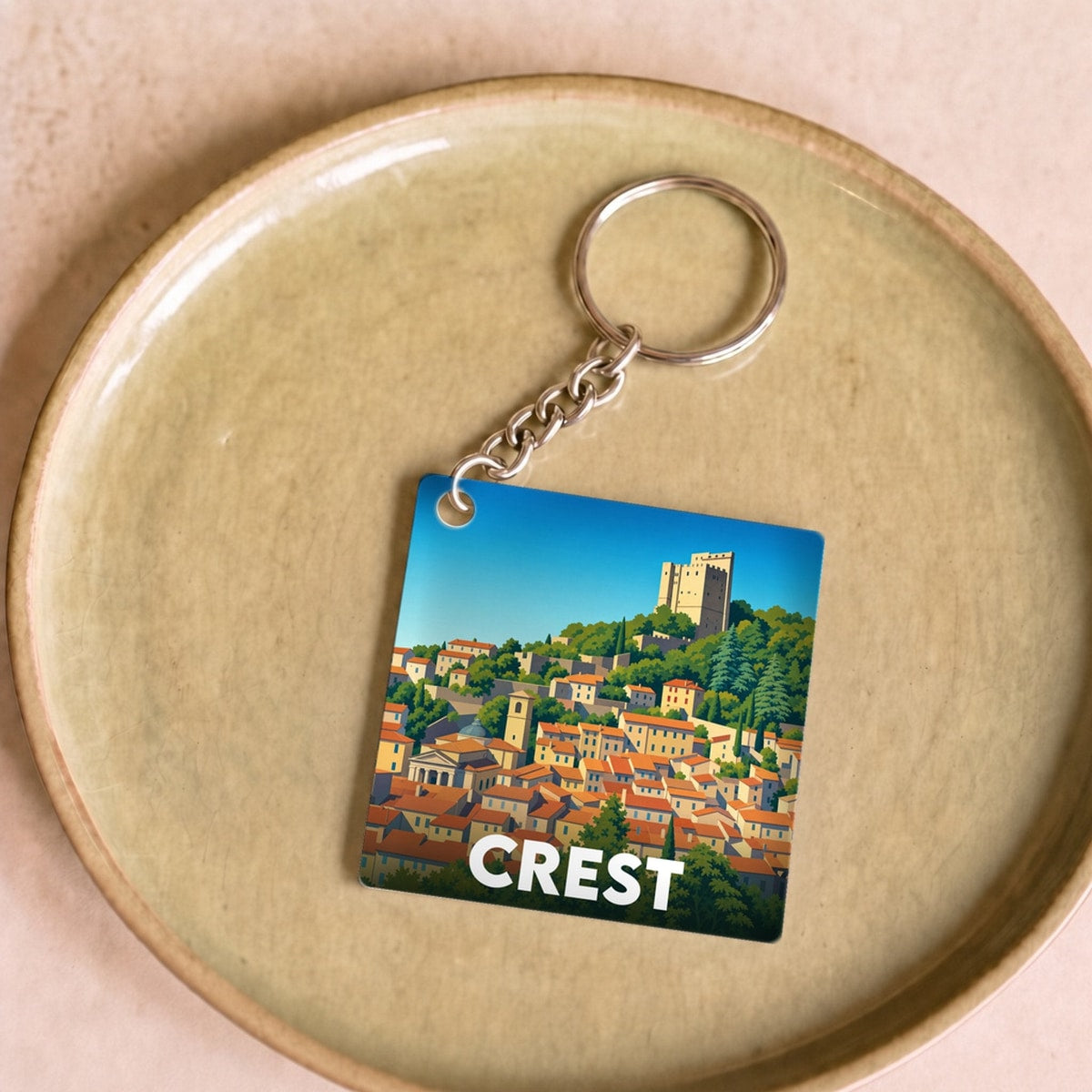 Porte-clés souvenir de la ville de Crest avec une illustration stylisée.