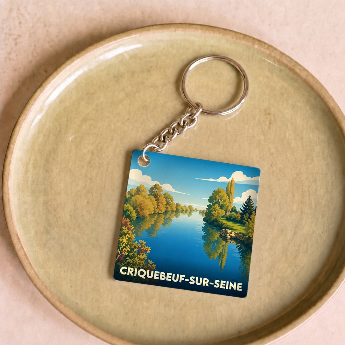 Porte-clés souvenir de la ville de Criquebeuf-sur-Seine avec une illustration stylisée.
