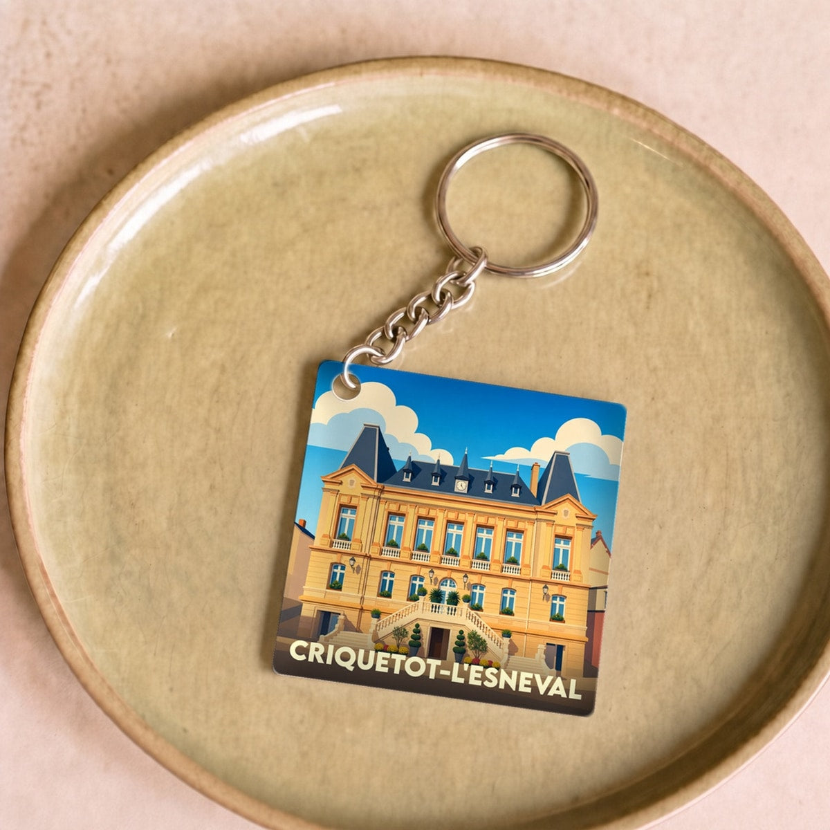 Porte-clés souvenir de la ville de Criquetot-l'Esneval avec une illustration stylisée.