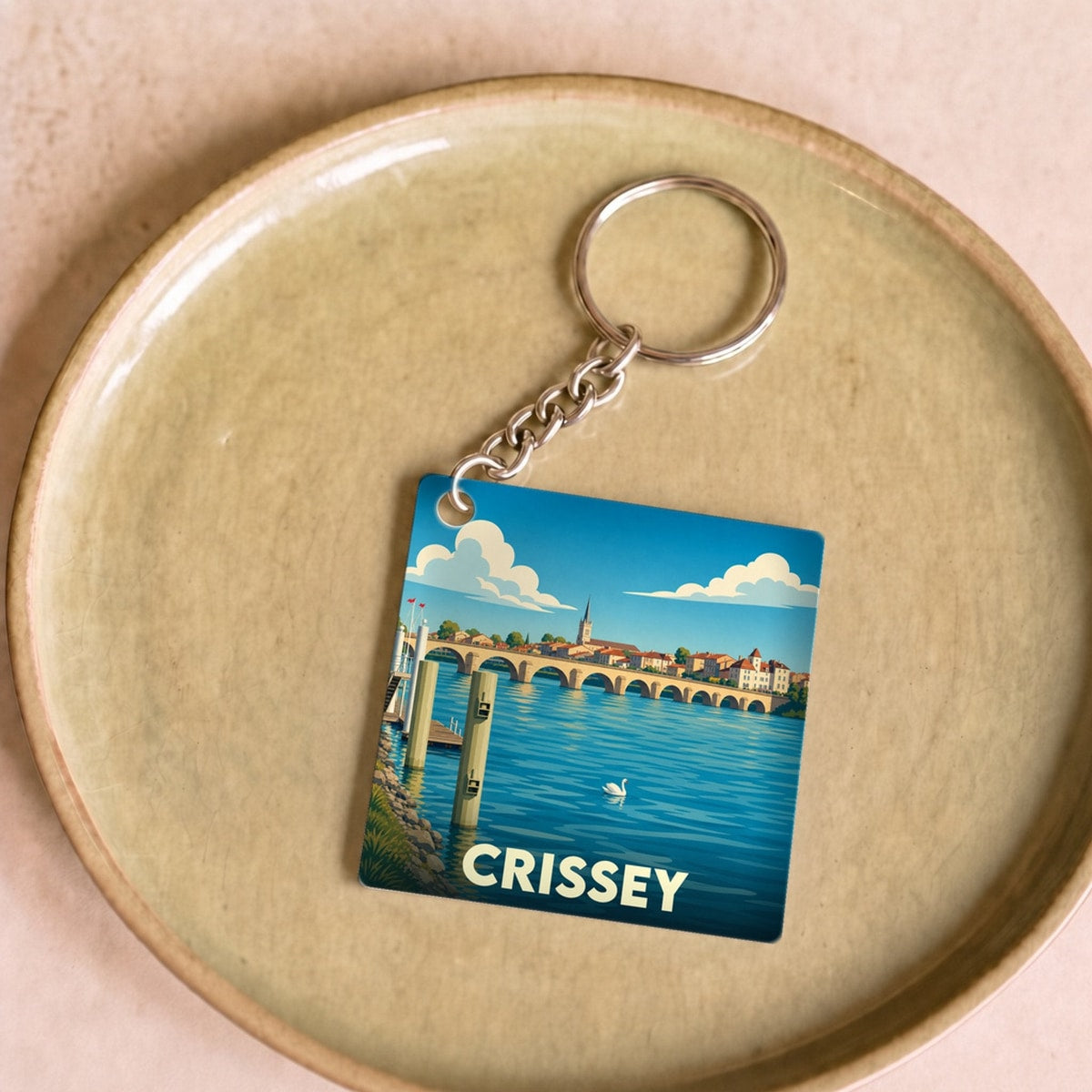 Porte-clés souvenir de la ville de Crissey avec une illustration stylisée.