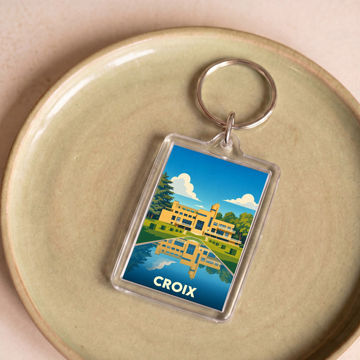 Porte-clés souvenir de la ville de Croix avec une illustration stylisée de la Villa Cavrois.