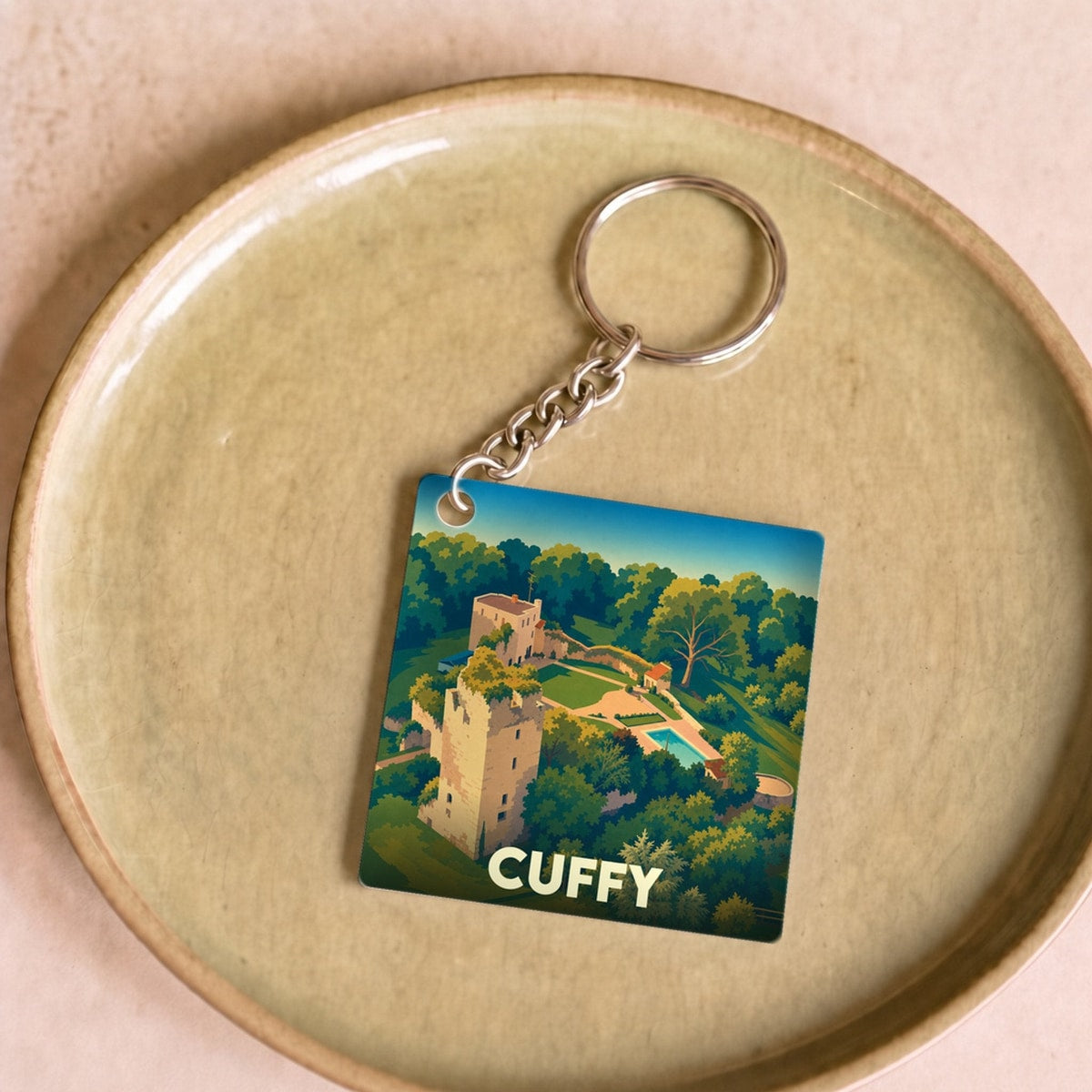 Porte-clés souvenir de la ville de Cuffy avec une illustration stylisée d'un château.