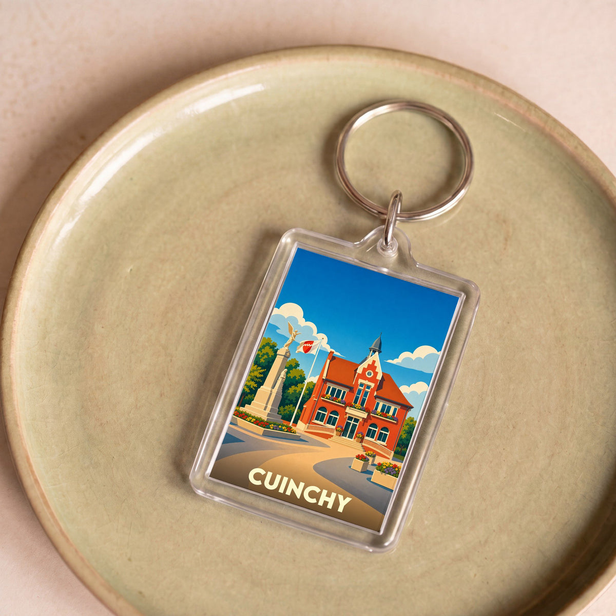Porte-clés souvenir de la ville de Cuinchy avec une illustration stylisée.