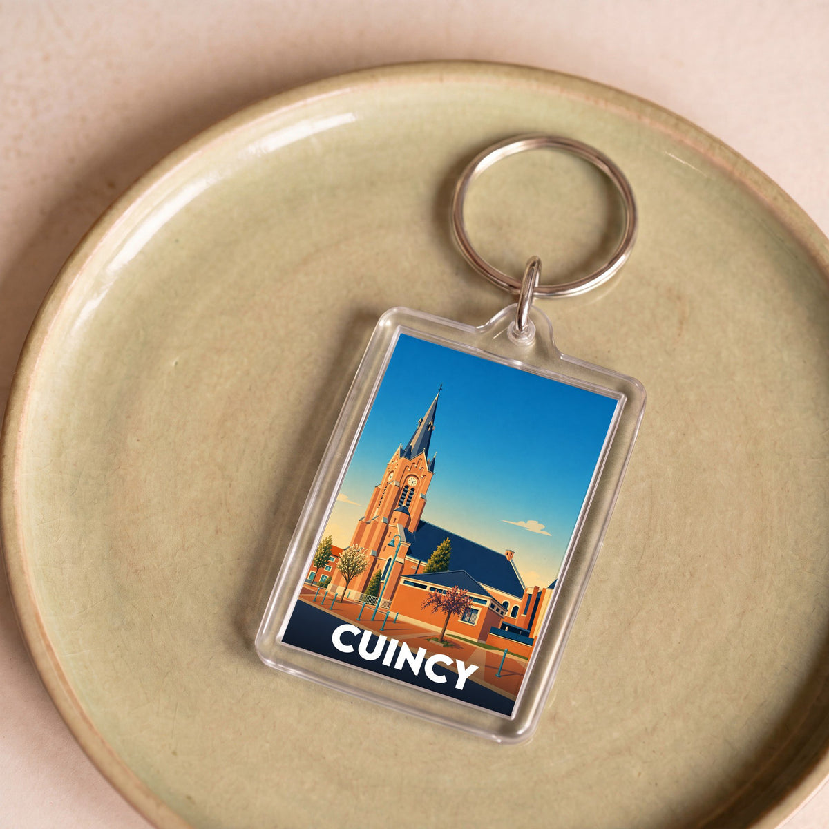 Porte-clés souvenir de la ville de Cuincy avec une illustration stylisée de son église.