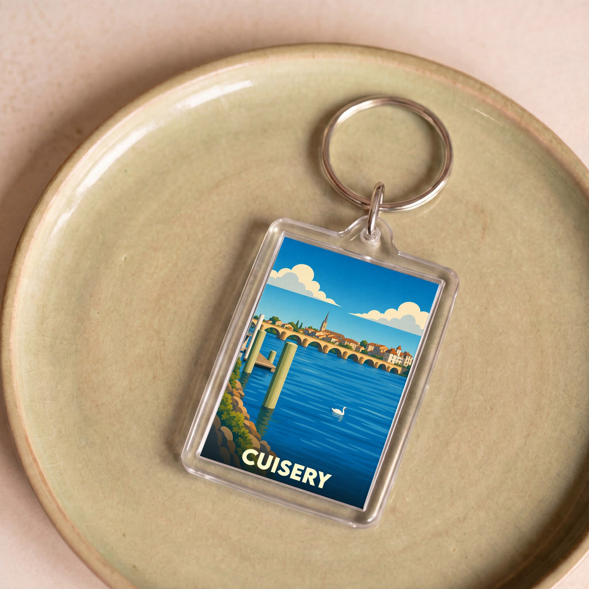 Porte-clés souvenir de la ville de Cuisery avec une illustration stylisée des bords de Seille.