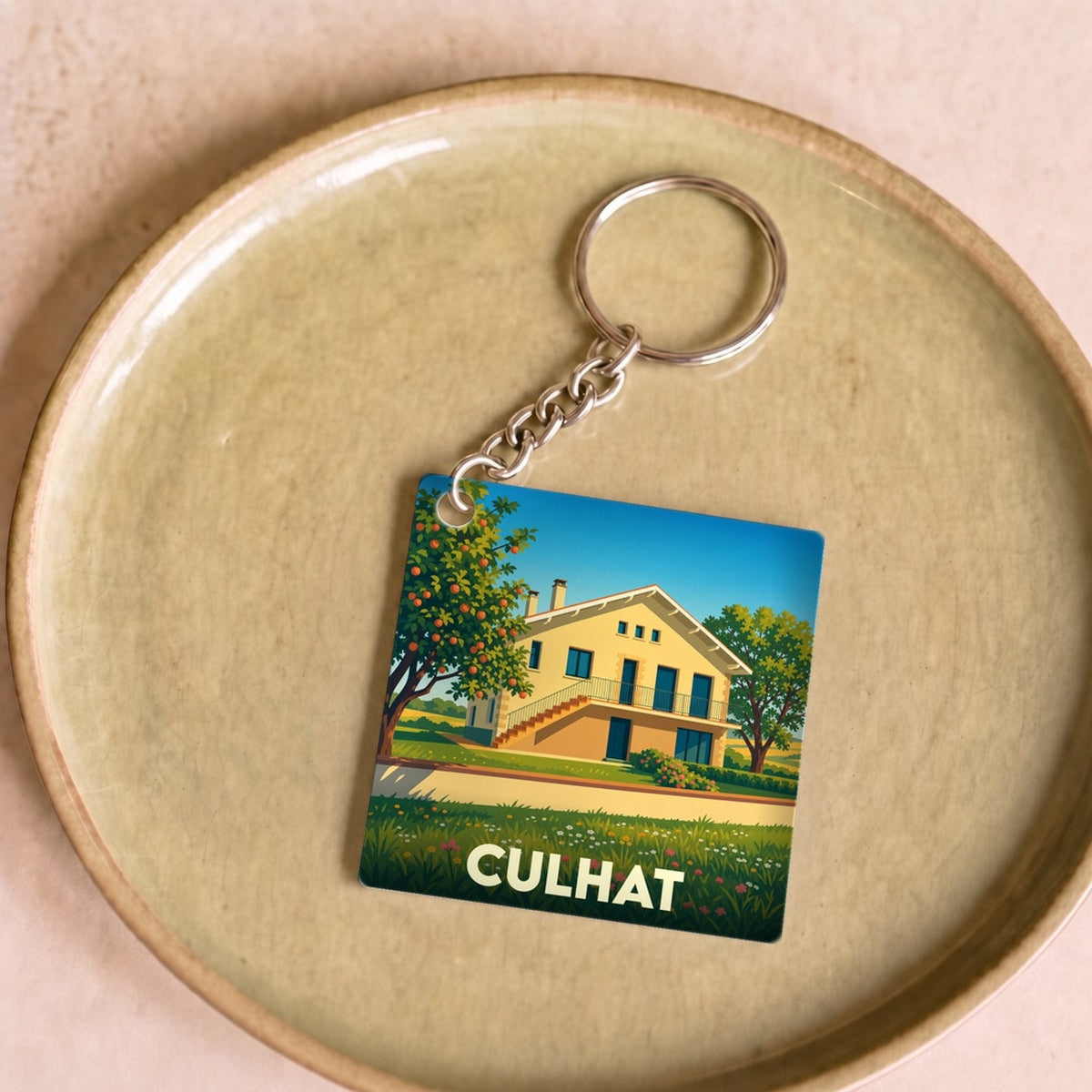 Porte-clés souvenir de la ville de Culhat avec une illustration stylisée d'une maison de campagne.