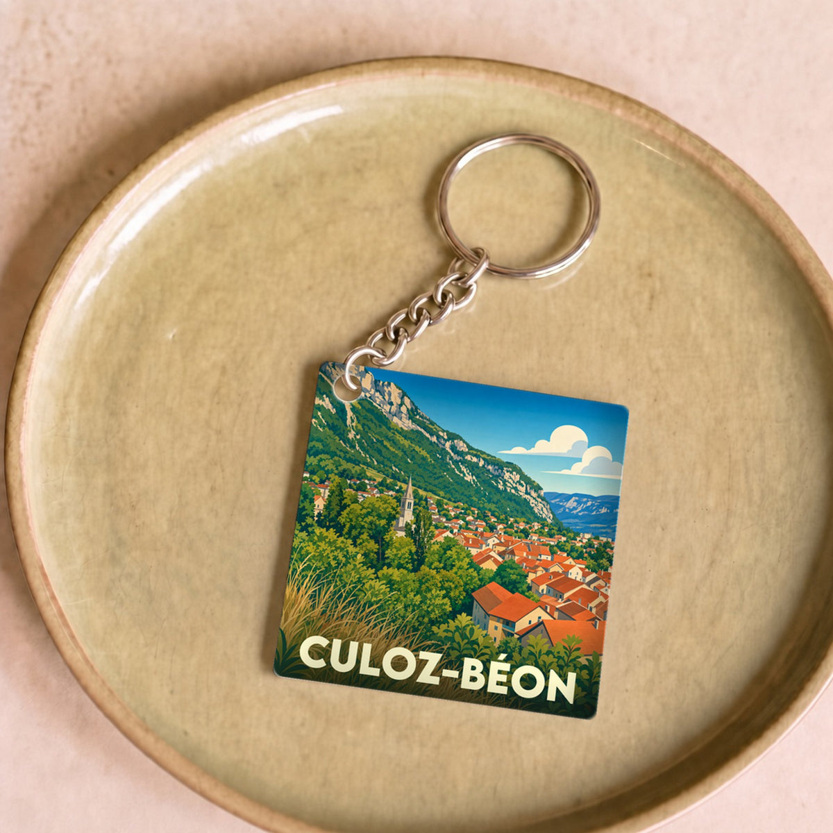 Porte-clés souvenir de la ville de Culoz-Béon avec une illustration stylisée.
