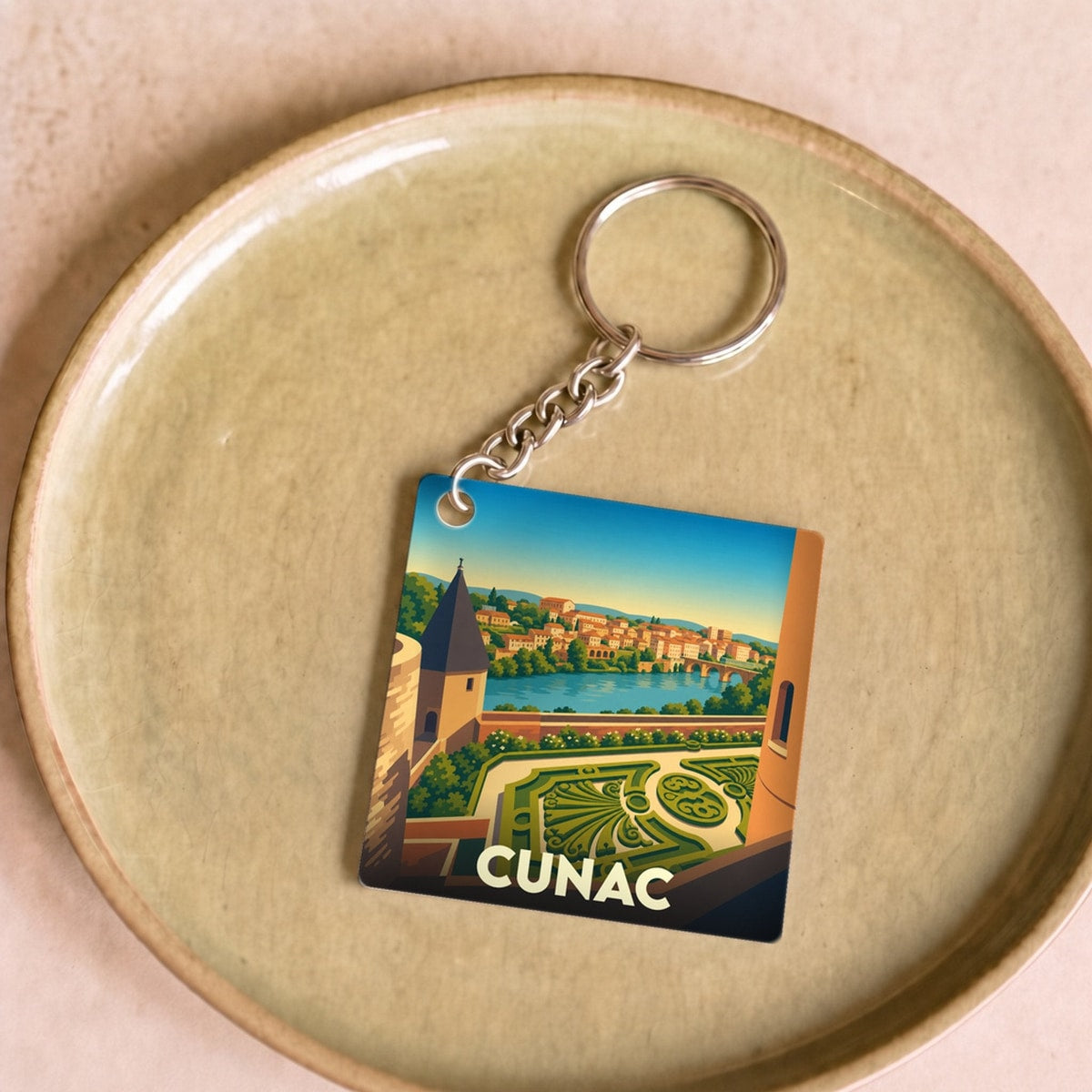 Porte-clés souvenir de la ville de Cunac avec une illustration stylisée.