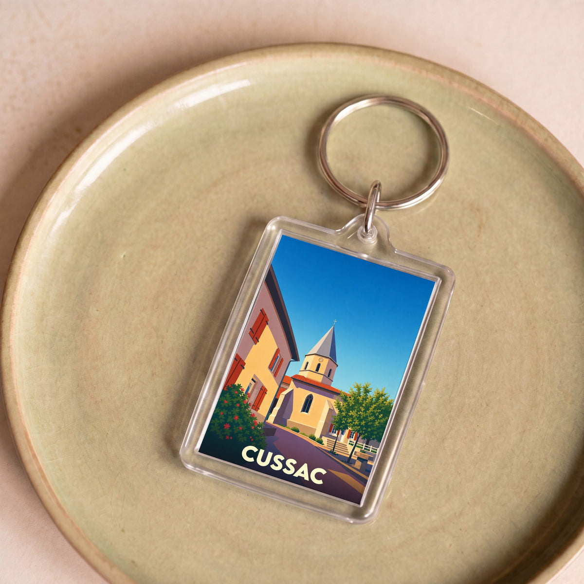 Porte-clés souvenir de la ville de Cussac avec une illustration stylisée.