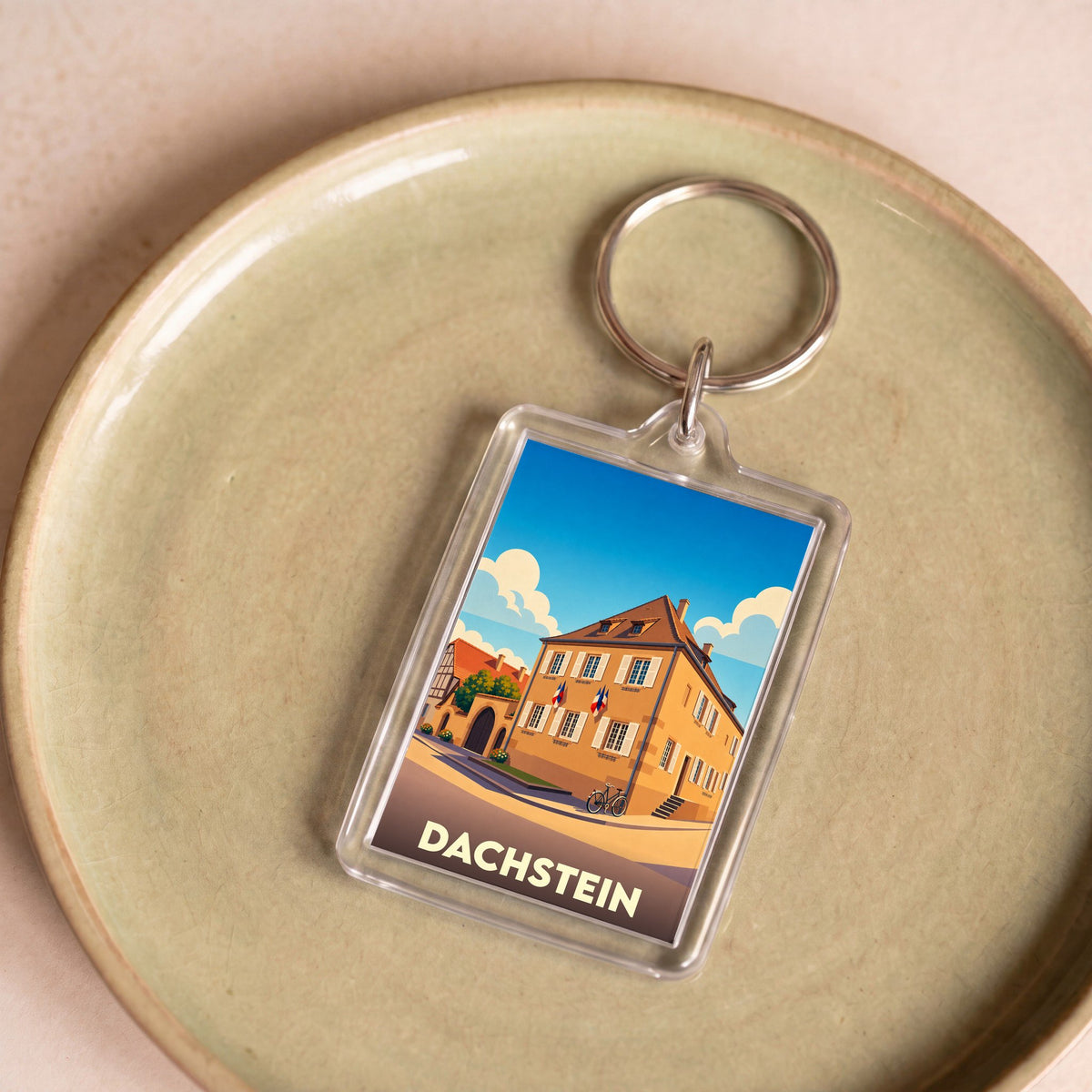 Porte-clés souvenir de la ville de Dachstein avec une illustration stylisée.