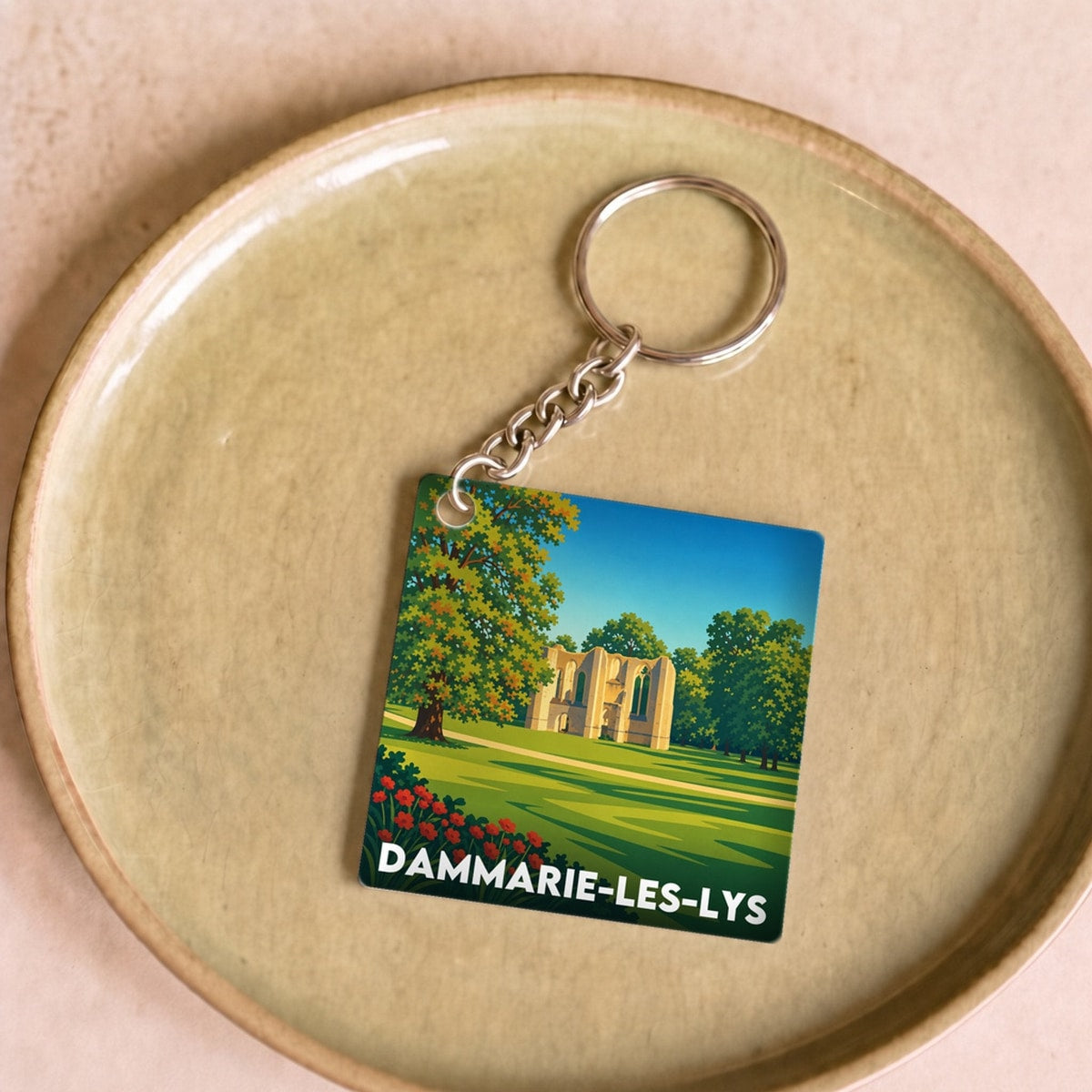 Porte-clés souvenir de la ville de Dammarie-les-Lys avec une illustration stylisée.