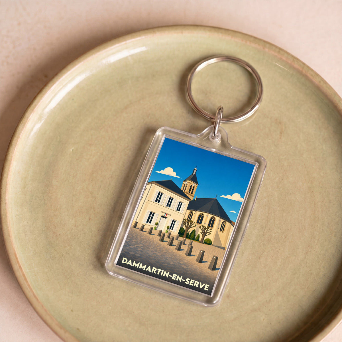Porte-clés souvenir de la ville de Dammartin-en-Serve avec une illustration stylisée.
