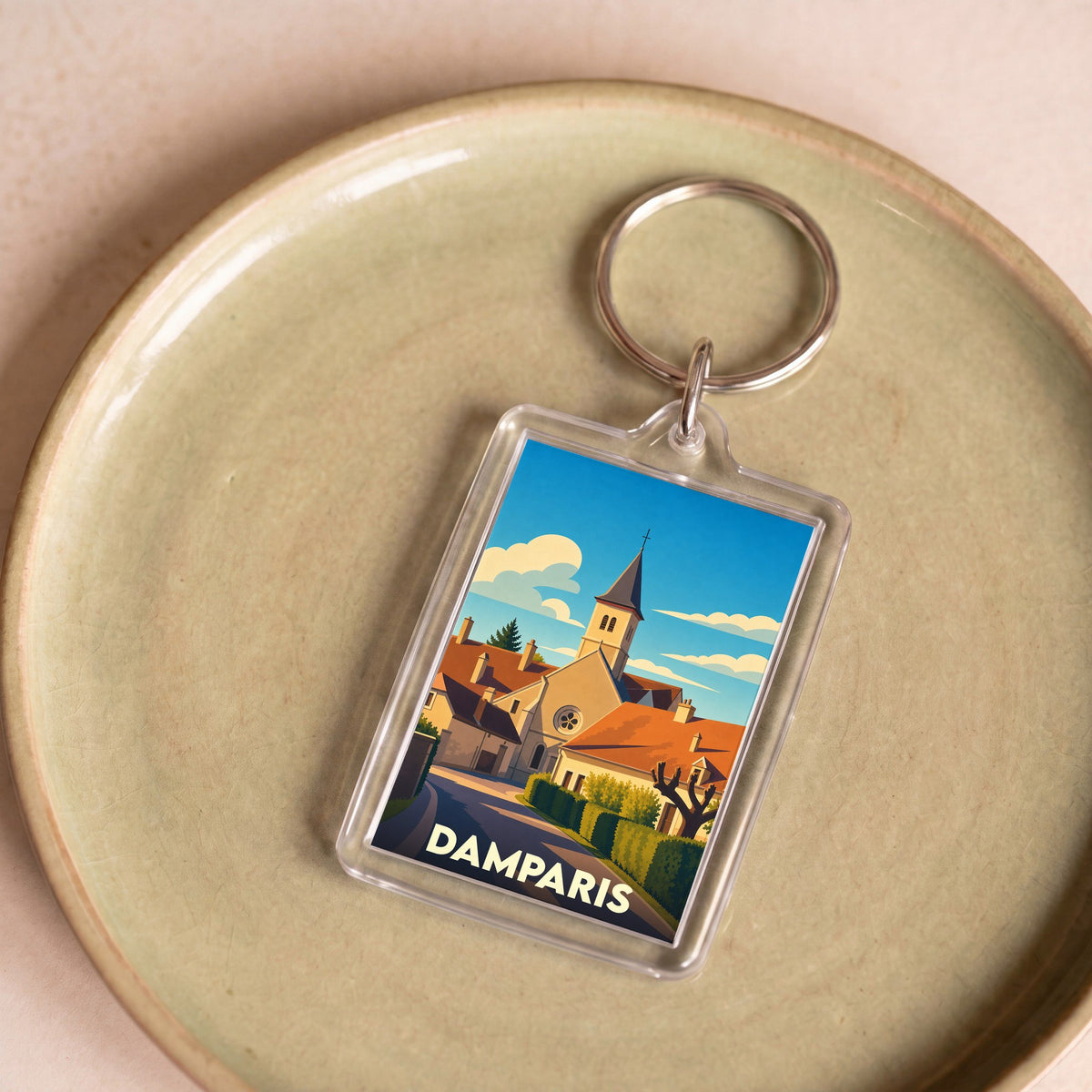 Porte-clés souvenir de la ville de Damparis avec une illustration stylisée.