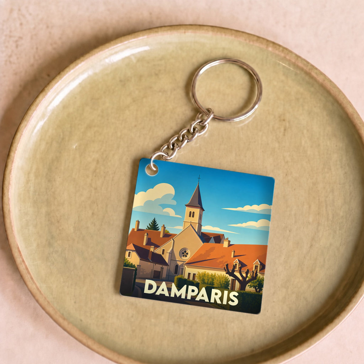 Porte-clés souvenir de la ville de Damparis avec une illustration stylisée.