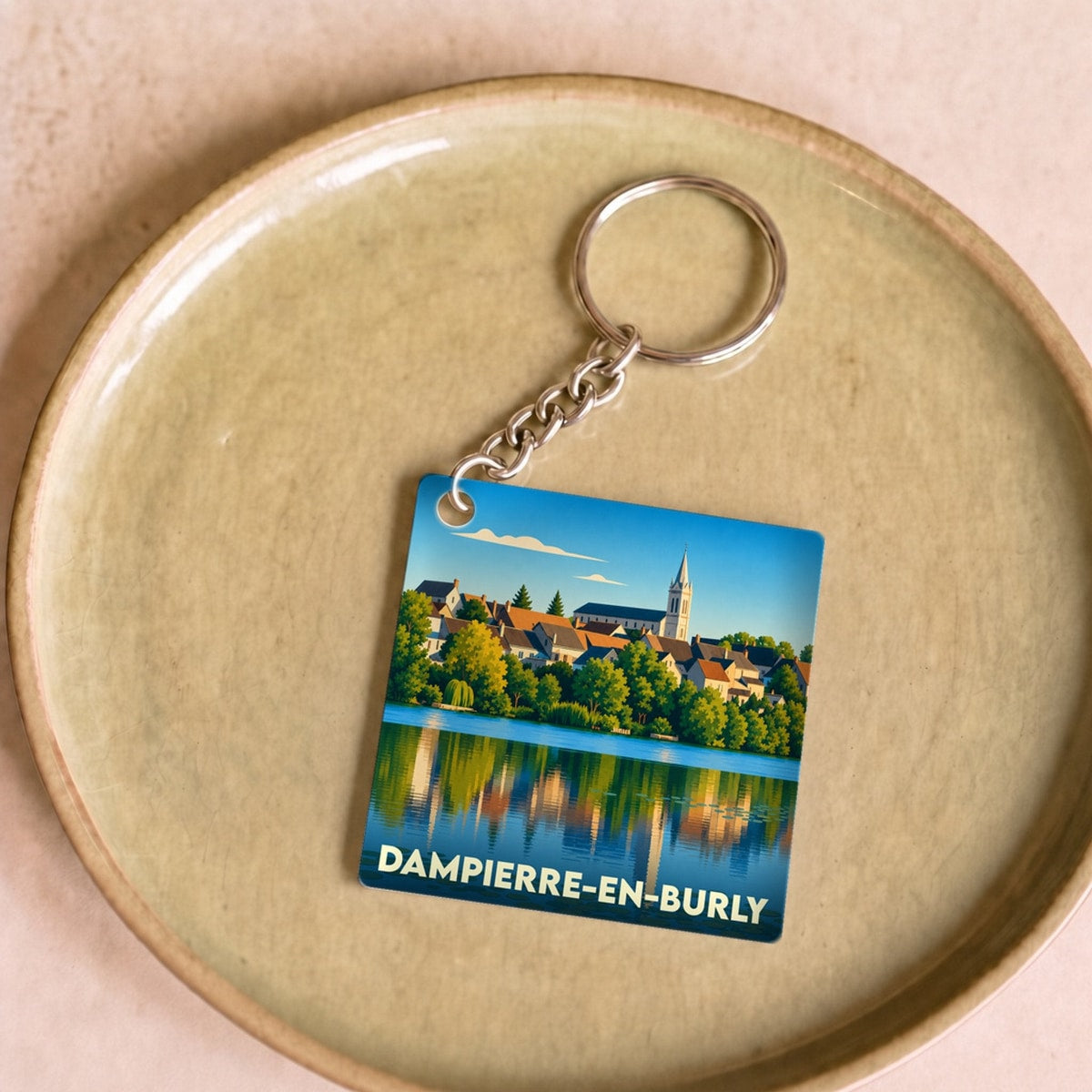 Porte-clés souvenir de la ville de Dampierre-en-Burly avec une illustration stylisée des bords de Loire.