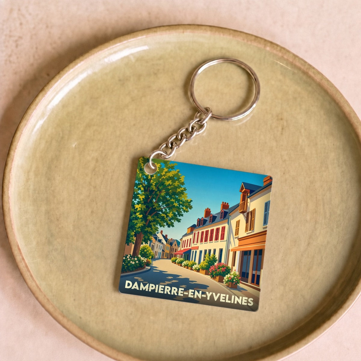 Porte-clés souvenir de la ville de Dampierre-en-Yvelines avec une illustration stylisée.
